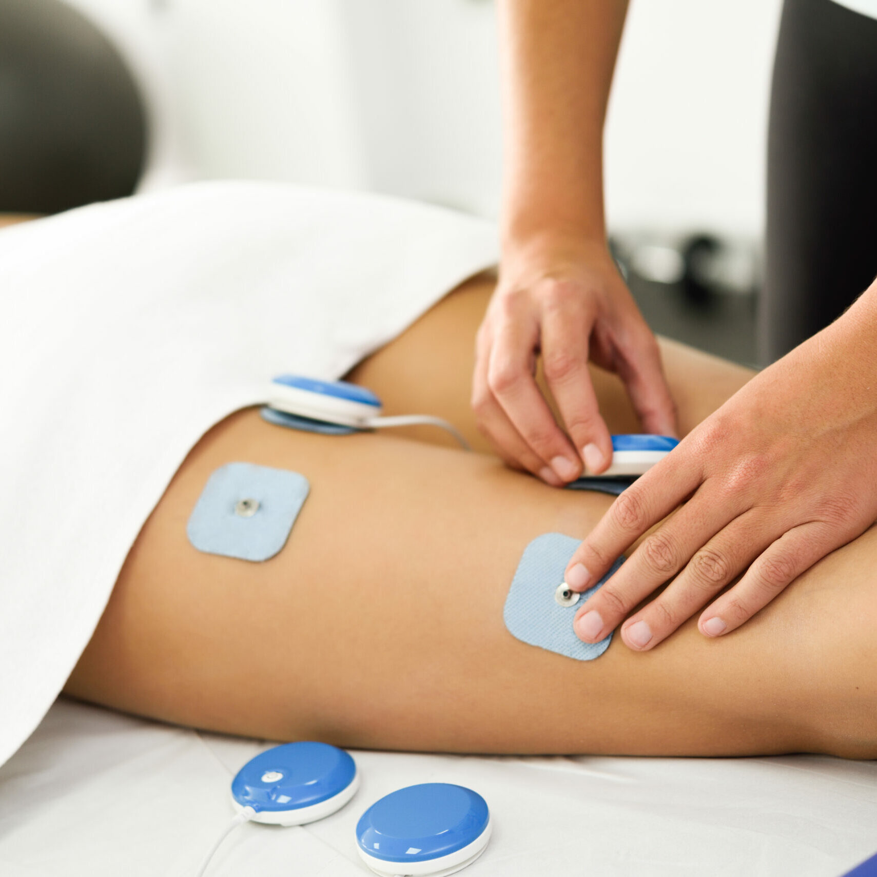 Physiotherapist applying electro stimulation in physical therapy