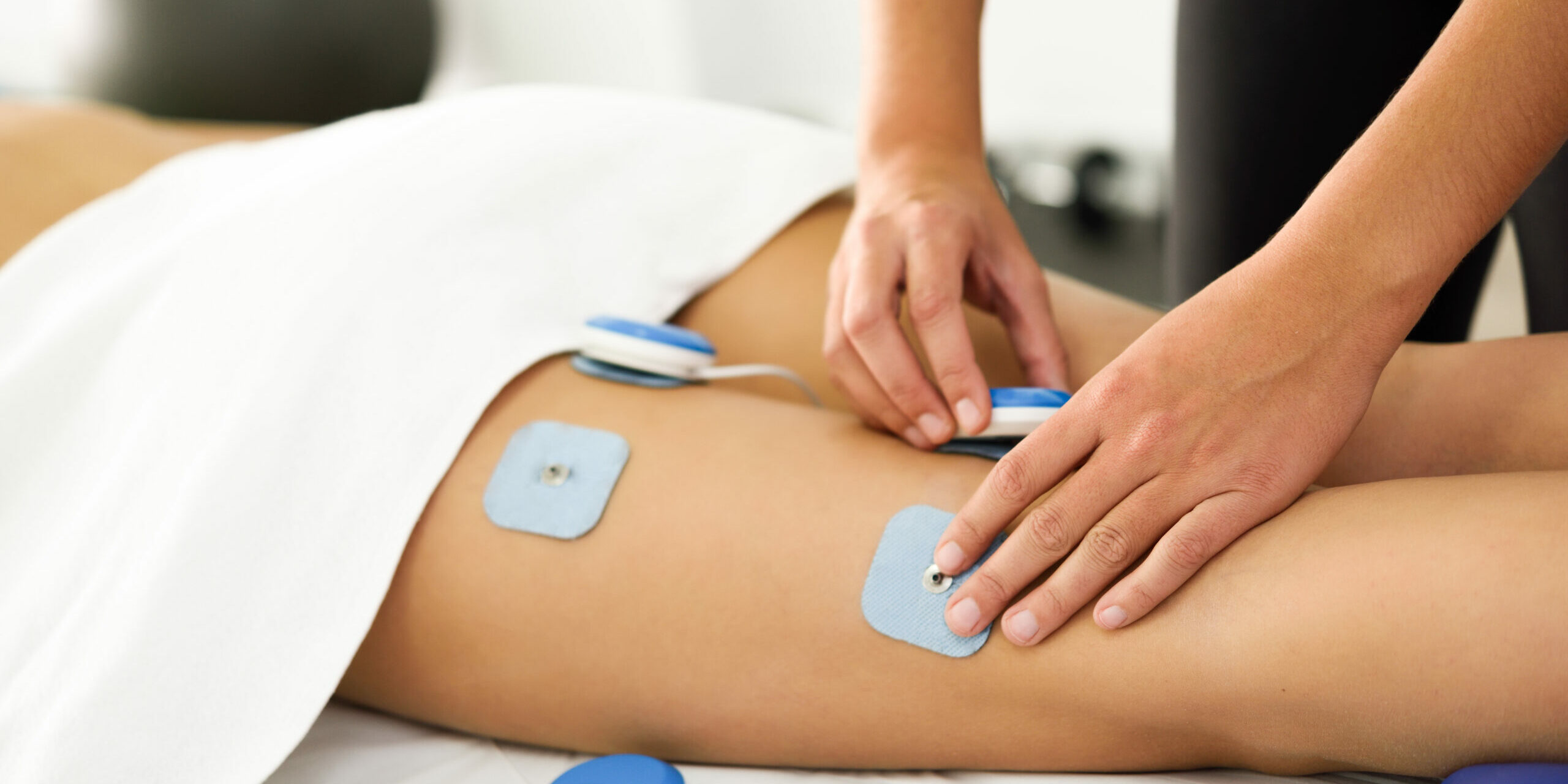 Physiotherapist applying electro stimulation in physical therapy